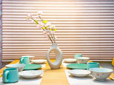 a table with a white vase with flowers in it at \u6e0b\u8c37\u897f\u5ddd\u30d3\u30eb in Tokyo