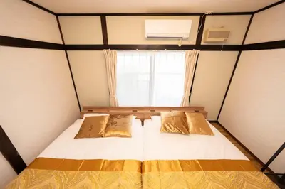a bed in a small room with a window at XS60 XROSS STAY Toyosu1 in Tokyo