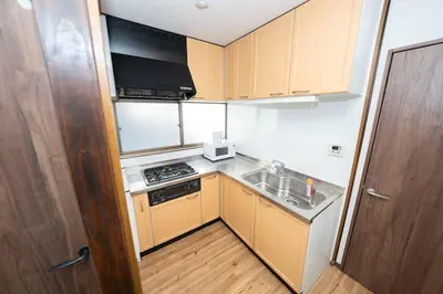 a small kitchen with a sink and a stove at XS60 XROSS STAY Toyosu1 in Tokyo