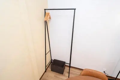 a mirror in the corner of a room with a chair at XS60 XROSS STAY Toyosu1 in Tokyo