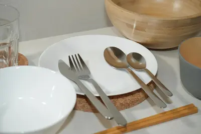 a white plate with cutlery on a table at INA HOUSE Koiwa 202 in Tokyo