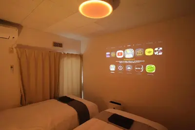 a room with two beds and a sign on the wall at INA HOUSE Koiwa 202 in Tokyo