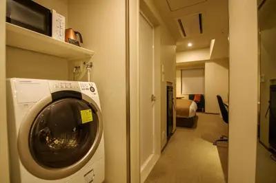 a washer and dryer in a hallway of a room at Tokyu Stay Ginza in Tokyo