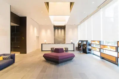 a lobby with a purple ottoman in a room at Tokyu Stay Ginza in Tokyo