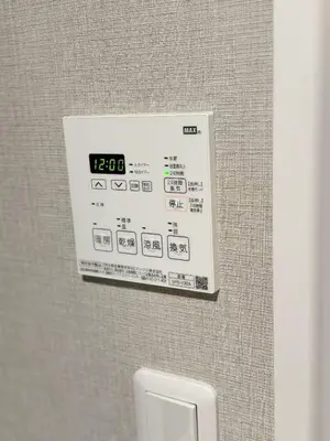 a clock on a wall above a urinal in a bathroom at ToKyo\u6d45\u8349 GA in Tokyo
