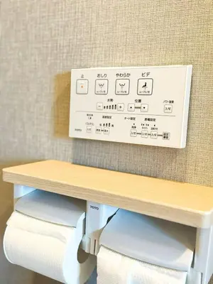 a box on the wall above a table with towels at ToKyo\u6d45\u8349 GA in Tokyo