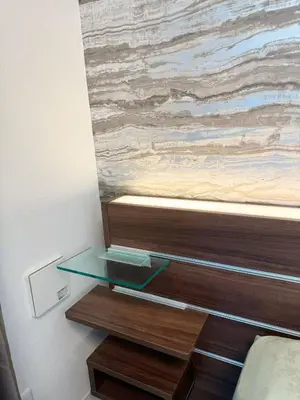a glass shelf in a bedroom with a painting on the wall at ToKyo\u6d45\u8349 GA in Tokyo
