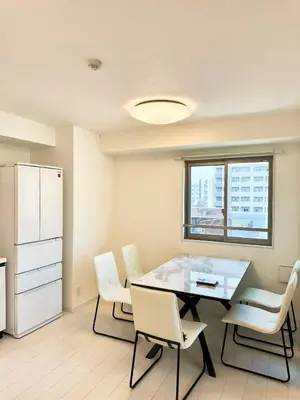 a dining room with a table and white chairs at ToKyo\u6d45\u8349 GA in Tokyo