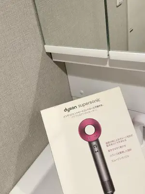 a sign next to a toilet with a purple handle at ToKyo\u6d45\u8349 GA in Tokyo