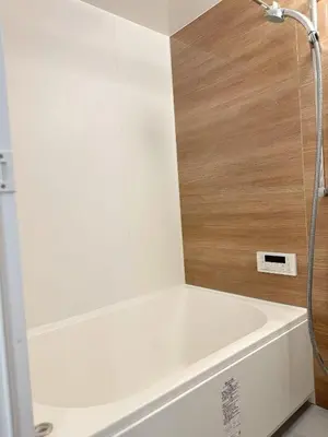 a white bath tub with a shower in a bathroom at ToKyo\u6d45\u8349 GA in Tokyo