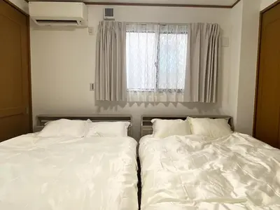 two beds sitting next to each other in a bedroom at kSF\u6c60\u888b\u672c\u753a2\u4e01\u76ee in Tokyo