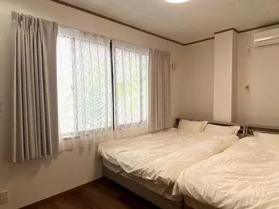 a bedroom with a bed and a large window at kSF\u6c60\u888b\u672c\u753a2\u4e01\u76ee in Tokyo