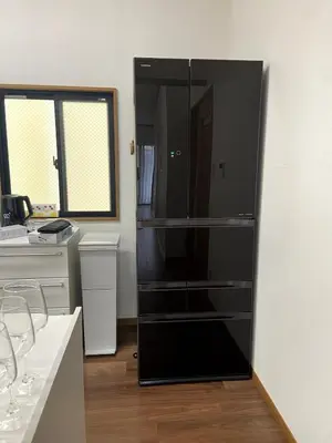 a black refrigerator in the corner of a kitchen at kSF\u6c60\u888b\u672c\u753a2\u4e01\u76ee in Tokyo