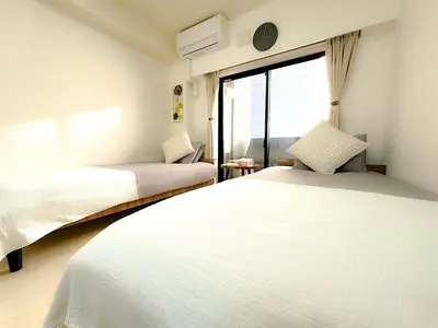 a bedroom with two beds and a window at Shinjuku Center 2 Singles Cozy Apt, Free WiFi in Tokyo