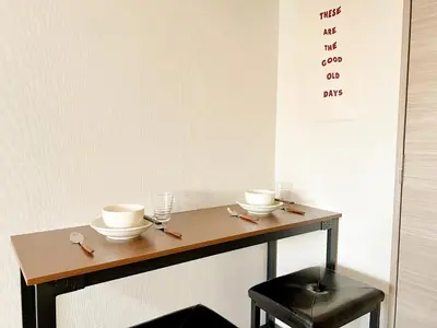 a wooden table with two cups and a stool at Shinjuku Center 2 Singles Cozy Apt, Free WiFi in Tokyo
