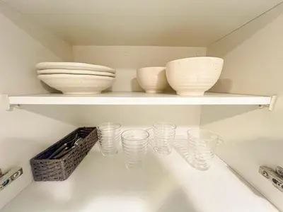 a shelf with bowls and cups on it at Shinjuku Center 2 Singles Cozy Apt, Free WiFi in Tokyo