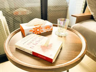 a table with two books and a glass on it at Shinjuku Center 2 Singles Cozy Apt, Free WiFi in Tokyo