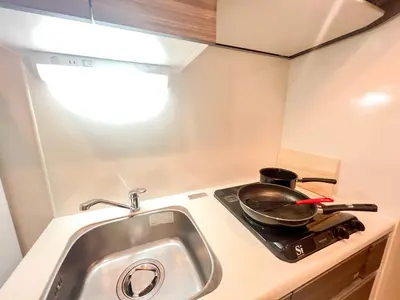 a frying pan on a stove in a tiny kitchen at Shinjuku Center 2 Singles Cozy Apt, Free WiFi in Tokyo