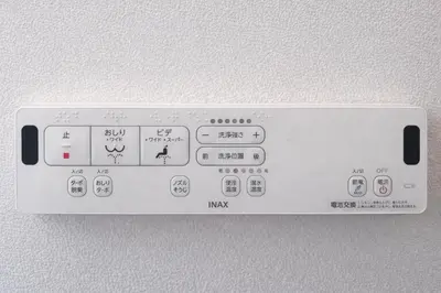 a white remote control attached to a wall at louis stage \u897f\u30f6\u539f 101\u5ba4 in Tokyo