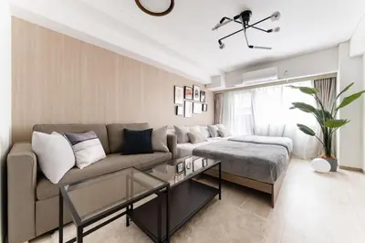 a living room with a couch and a table at Dogenzaka Hotel 306 in Tokyo