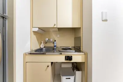 a small kitchen with a sink in a room at Dogenzaka Hotel 306 in Tokyo