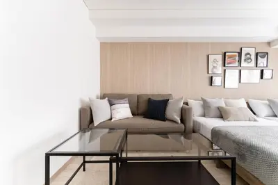 a living room with a couch and a glass coffee table at Dogenzaka Hotel 306 in Tokyo