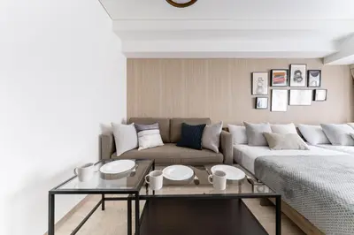 a living room with a couch and a coffee table at Dogenzaka Hotel 306 in Tokyo