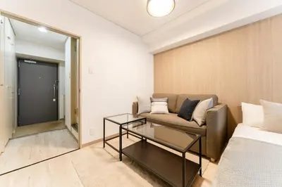 a living room with a couch and a glass table at Dogenzaka Hotel 306 in Tokyo