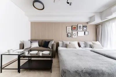 a living room with two beds and a couch at Dogenzaka Hotel 306 in Tokyo