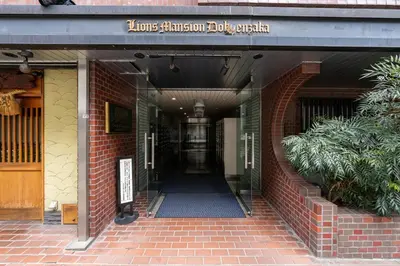 a hallway leading to a building with a sign on it at Dogenzaka Hotel 306 in Tokyo