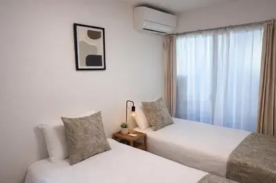a hotel room with two beds and a window at louis stage \u897f\u30f6\u539f 102\u5ba4 in Tokyo