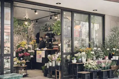 a flower shop with lots of pots of flowers at louis stage \u897f\u30f6\u539f 102\u5ba4 in Tokyo