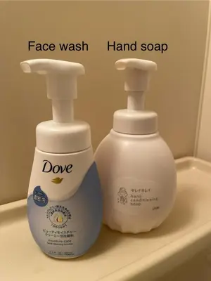 two bottles of face wash and hand soap sitting on a sink at west16 in Tokyo