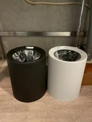 two trash cans sitting next to each other on a counter at west16 in Tokyo
