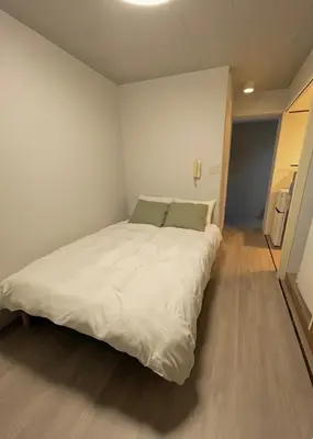 a bedroom with a large white bed in it at west16 in Tokyo
