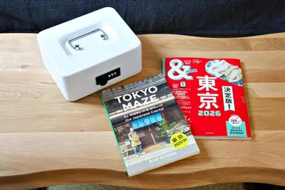 a table with a box and a magazine and a book at FelizLife \u5357\u99ac\u8fbc 201 in Tokyo