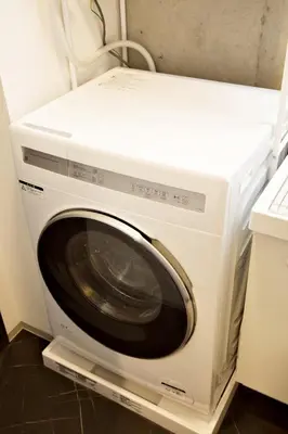 a white washing machine sitting in a kitchen at FelizLife \u5357\u99ac\u8fbc 201 in Tokyo