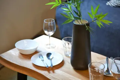 a wooden table with a vase with a plant on it at FelizLife \u5357\u99ac\u8fbc 201 in Tokyo