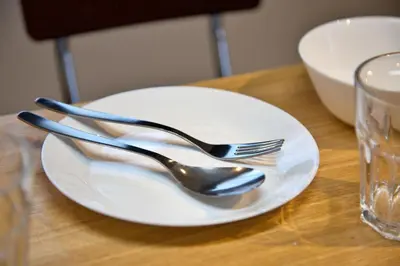 a white plate with fork and spoon on a table at FelizLife \u5357\u99ac\u8fbc 201 in Tokyo