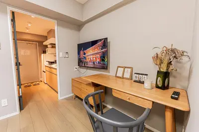 a room with a wooden desk with a vase of flowers at Mi-Hotel Asakusa Senso-ji in Tokyo