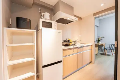 a kitchen with a white refrigerator and a sink at Mi-Hotel Asakusa Senso-ji in Tokyo