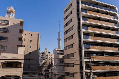 a tall building with a tv tower in the background at Mi-Hotel Asakusa Senso-ji in Tokyo