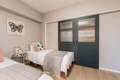 a bedroom with two beds and a door with a butterfly decoration at Mi-Hotel Asakusa Senso-ji in Tokyo