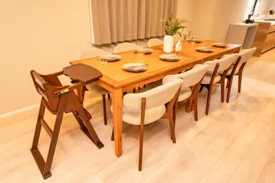 a wooden dining room table with chairs and a table at group and community house in Tokyo