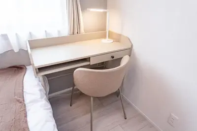 a desk with a chair next to a bed at group and community house in Tokyo