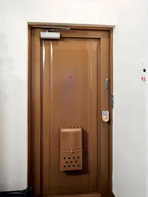 a brown door with a box on the side of it at Shibuya Hotel 502 in Tokyo