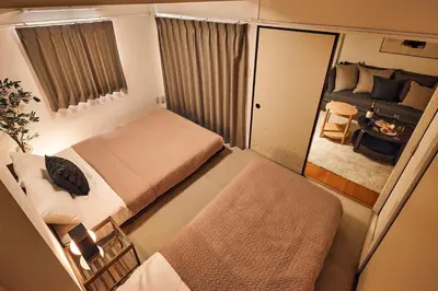 a small room with two beds and a couch at Shibuya Hotel 502 in Tokyo