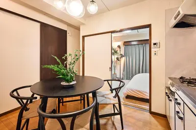 a small kitchen and dining room with a table and chairs at Shibuya Hotel 502 in Tokyo