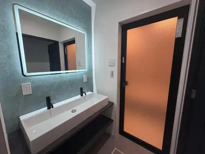 a bathroom with a white sink and a mirror at COTO Premium Kyodo in Tokyo