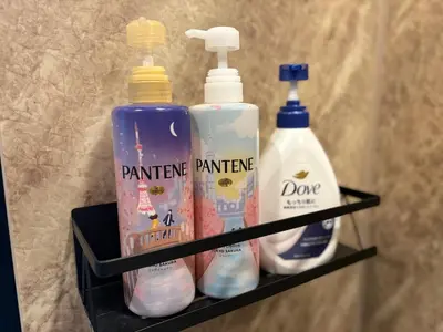a shelf with three bottles of cleaning products on it at COTO Premium Kyodo in Tokyo